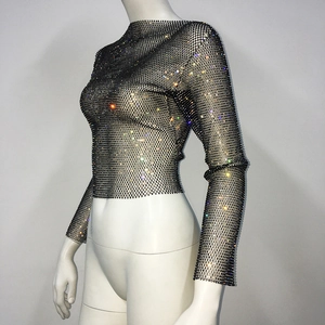 Detailed view of black fishnet long sleeve top with sparkling rhinestones decoration
