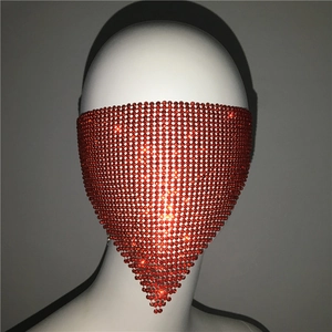 Macro detail of red rhinestone mesh mask with triangular drape for parties and events