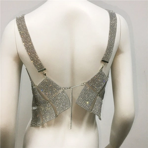 Detailed view of silver rhinestone body chain with shiny metal links and adjustable straps