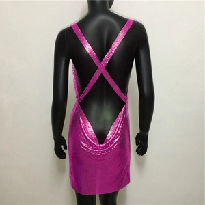 Detail of pink metallic sequin mini dress featuring cross back straps and open back design