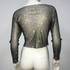 Close-up of black mesh crop top featuring vibrant rhinestones and transparent net texture
