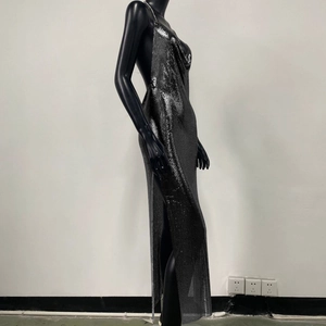 Detailed side view of silver metallic sequin dress with sexy high slit and open back design