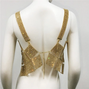 Macro detail of golden rhinestone chain link vest with sparkling diamond back straps