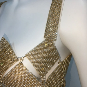 Detail shot of the golden rhinestone mesh top showing geometric crystal arrangement