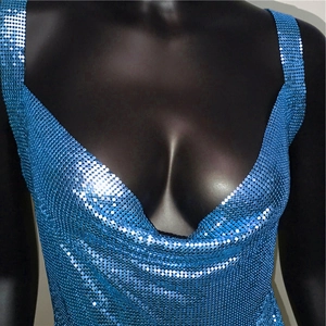 Detail of blue metallic sequin dress with deep V-neck and shiny reflective texture