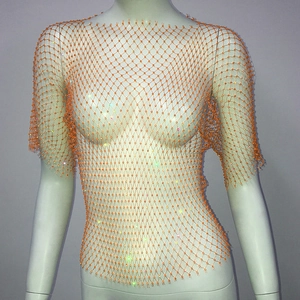 Gros plan d'un haut en maille orange avec strass colorés scintillants sur un mannequin blanc