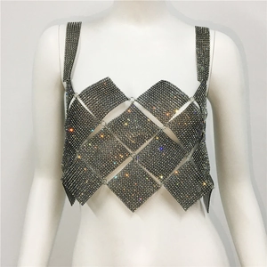 Detailed macro view of sparkly rhinestone diamond mesh patchwork on a black crop top