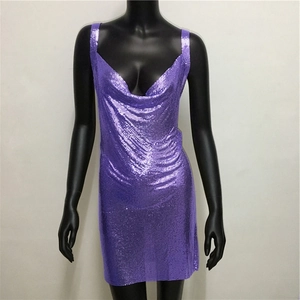 Detail of purple chainmail mini dress showing the metallic sequin texture and V-neckline