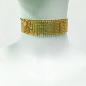 Detail of gold metal sequin choker necklace featuring wide mesh chain design and reflective discs