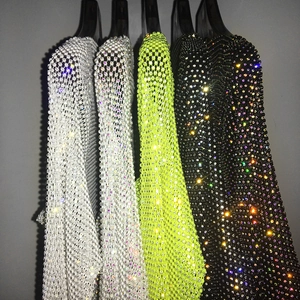 Detail view of sparkly rhinestone mesh tops in white, neon green and black colors