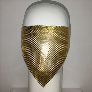 Detail of a golden metal mesh face mask with round disc sequins for party and stage wear