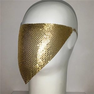 Detail view of a gold metal sequin veil mask with triangle draped fringe and shiny finish