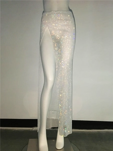 Detail of white mesh skirt featuring sparkling rhinestones and a high side slit design