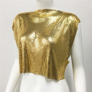 Macro detail of gold metallic sequin crop top with shimmery knit texture for parties