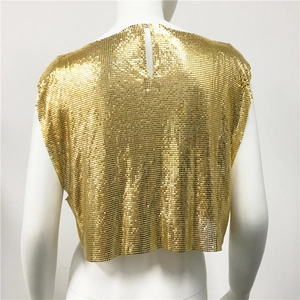 Detail view of the back cutout and golden metallic chainmail texture of this crop top