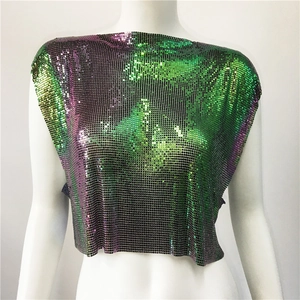 Detail of iridescent sequin metal mesh top with circular scales in party punk style