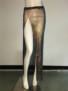 Close-up of sparkling rhinestone mesh fabric with high side slit detail for party wear