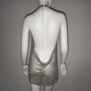 Detail of silver sequin party dress showing metallic chainmail mesh and halter neck style
