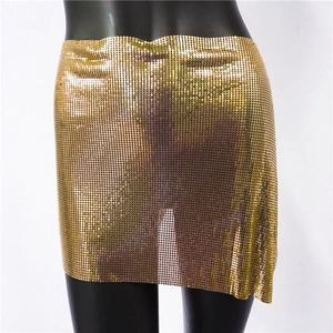 Detailed view of sexy gold metal mesh mini skirt with shimmering sequin texture