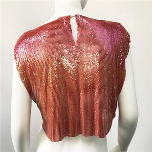 Macro detail of gradient pink and orange metal sequin mesh crop top with buckle closure