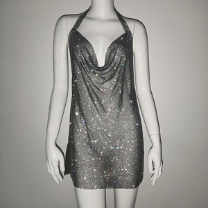 Close-up of sparkling silver rhinestone mesh fabric on a sexy halter neck party dress