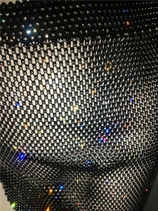 Macro detail of sexy black mesh fabric with sparkling rhinestones on diamond grid pattern