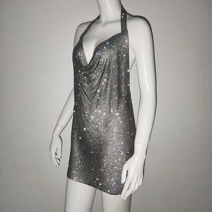 Macro detail of sparkly chainmail fabric on a deep silver halter party dress