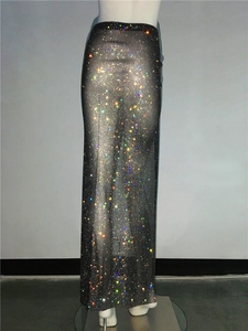 Close-up of luxury black mesh maxi skirt with shimmering rhinestones and side slit