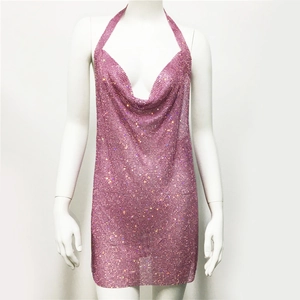 Macro shot of pink metallic mesh dress fabric with shimmering rhinestone details