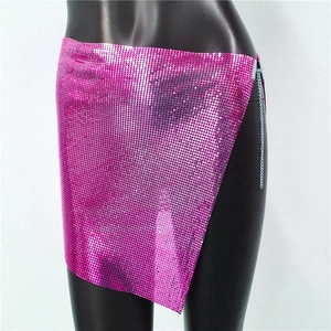 Detail of bright pink metallic sequin mini skirt with side chain and chainmail texture