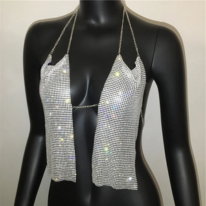 Close-up of sparkling silver rhinestone mesh halter top with metallic chain details