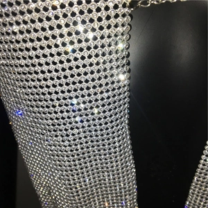 Detailed view of silver mesh top with glittering rhinestones for party wear