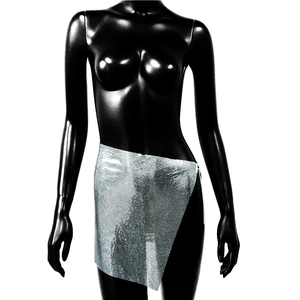 Detailed macro view of silver metallic sequin mesh fabric on an asymmetrical mini skirt