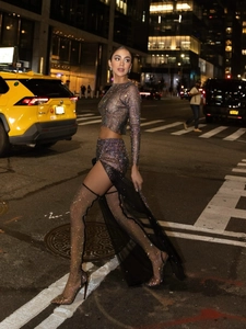 Women's black mesh two-piece crop top and high slit skirt set with sparkling rhinestones