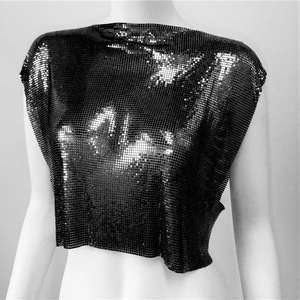 Detail of black metallic sequin mesh fabric on a sexy crop top for party wear