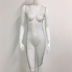 Macro detail of silver mesh dress with glittering rhinestones on a white mannequin