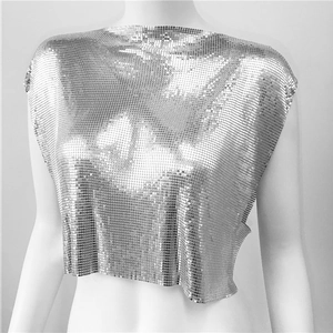 Macro detail of shimmering silver metallic chainmail mesh and disc sequins on a crop top