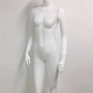Close-up of white mesh fishtail dress featuring shimmering rhinestones and cut-out texture