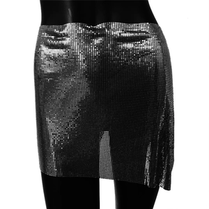 Close-up of silver metal mesh sequin mini skirt with shimmering disco party texture