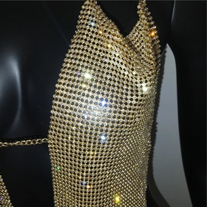 Detailed macro view of sparkling rhinestone mesh and gold metal chain links