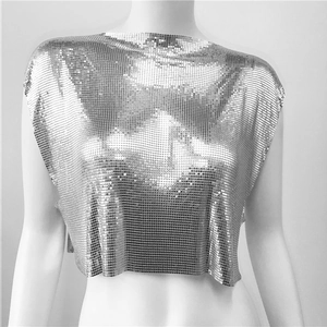 Detailed close-up of silver sequin metal mesh fabric on a stylish crop top tank