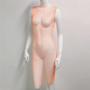 Close-up of bright orange rhinestone mesh dress with shimmering crystal details