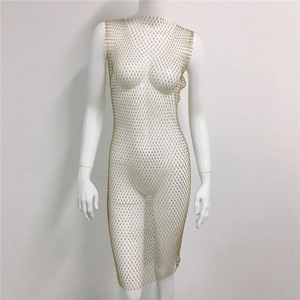 Detail of gold mesh rhinestone dress featuring a sheer sleeveless grid and fishnet texture