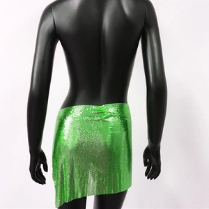 Detail of shimmering green metallic mesh sequins on a party mini skirt for women