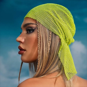 Neon green rhinestone mesh headband shown on model against a bright blue sky background