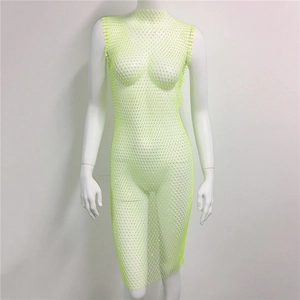 Detail of neon green rhinestone fishnet dress showing intricate mesh and sparkling crystals