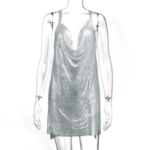 Detail of silver chainmail dress featuring metallic sequins and a deep V-neckline