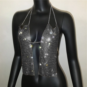 Detail of rhinestone mesh halter top featuring silver crystal chains and plunging neckline