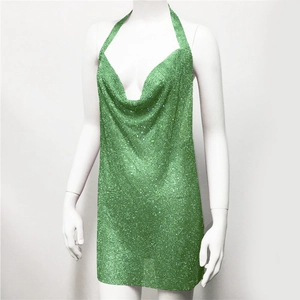 Detail of green sequin halter dress with deep V-neck and shimmering rhinestone texture