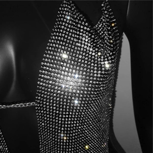 Close-up of sparkling rhinestone mesh top with metal chains for party events